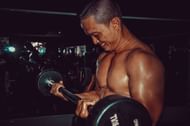 Reverse grip curls target the biceps and forearms. (Photo via Pexels/Tristan Le)